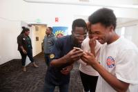 boys looking at a phone smiling